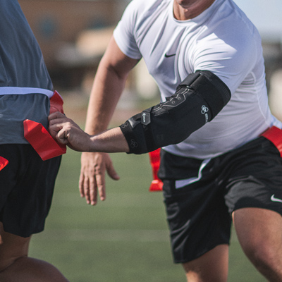 Athlete doing drills wearing an elbow brace