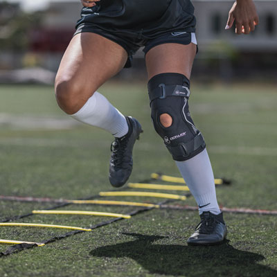 Athlete doing drills wearing a knee brace