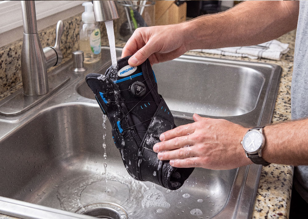 Aircast AirSport+® ankle brace being washed in the kitchen sink