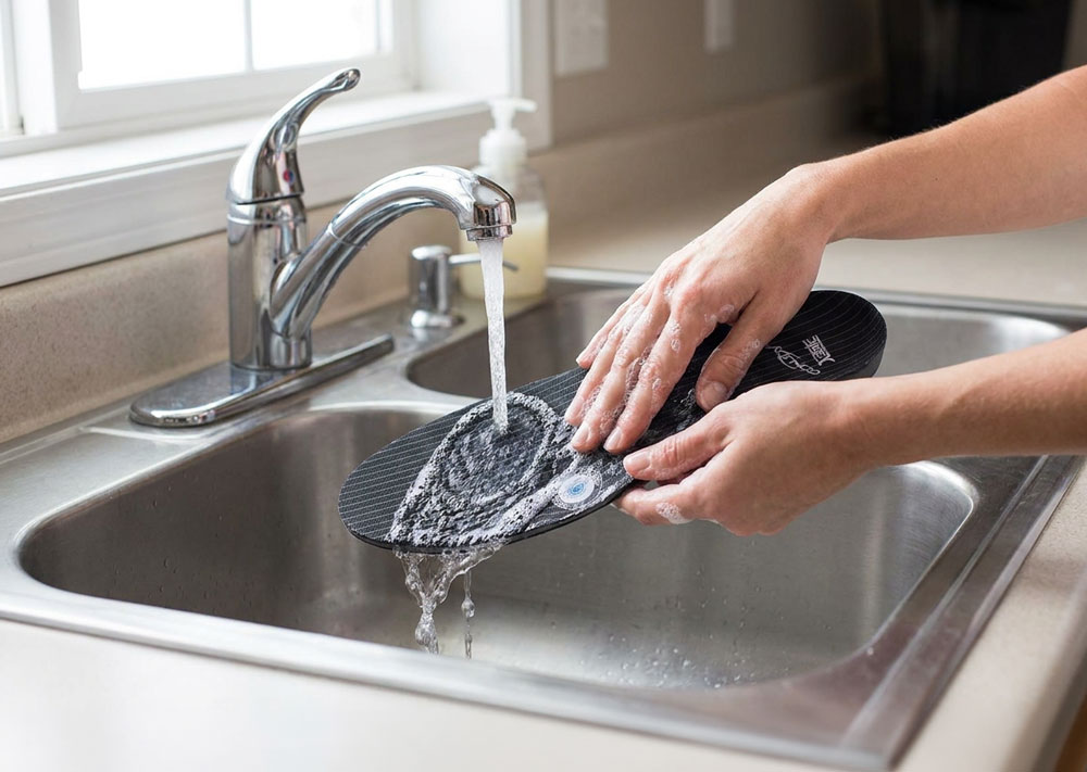 DonJoy® Arch Rival Pair being washed in the kitchen sink