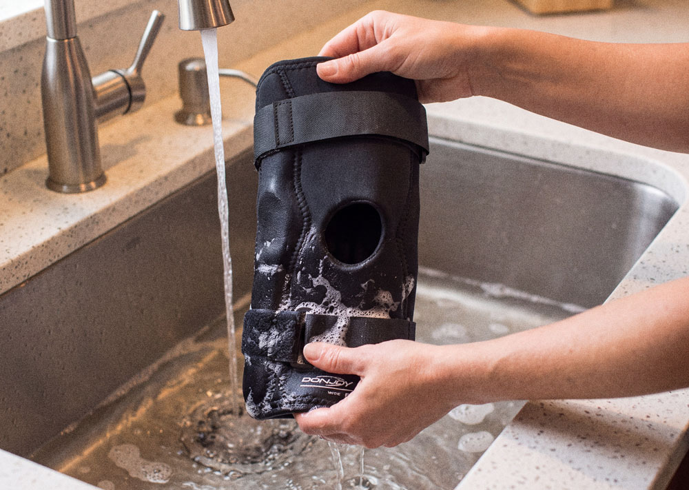 DonJoy Economy Hinged Knee Brace being washed in the kitchen sink