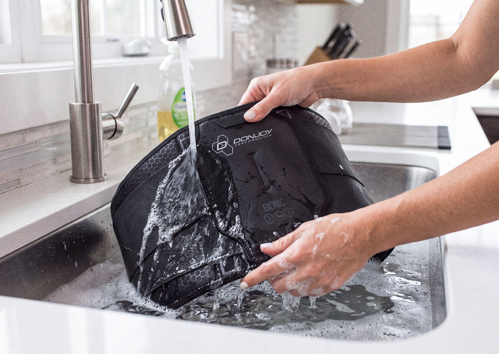 DonJoy Performance Bionic Back Support being washed in a kitchen sink