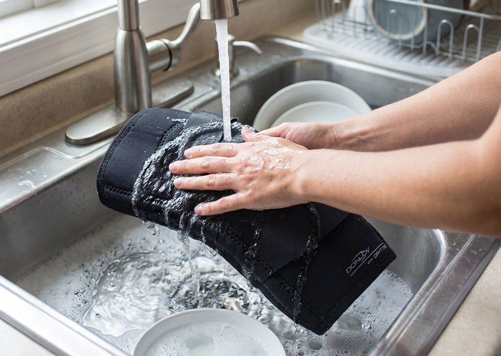DonJoy Performer Hinged Patella Knee Brace being washed in the kitchen sink