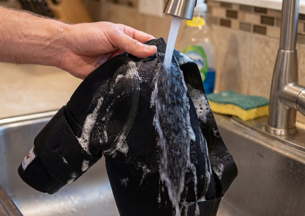 DonJoy Sully Shoulder Brace being washed in a kitchen sink