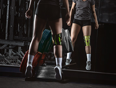 Athlete wearing the DonJoy Performance Bionic™ FullStop Knee Brace kicking a soccer ball