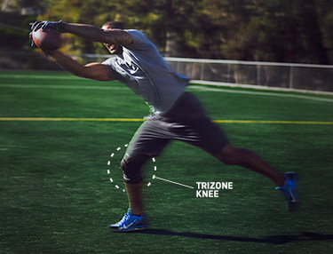 Athlete wearing Trizone Knee Sleeve catching the football