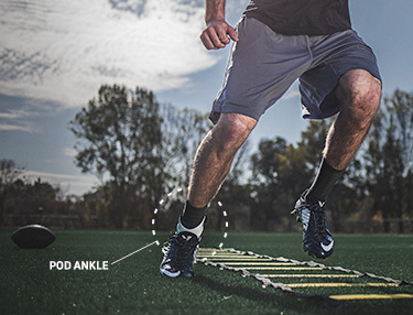 Athlete wearing the POD ankle brace doing football training drills