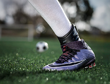 Athlete wearing the DonJoy Performance POD ankle Brace playing soccer
