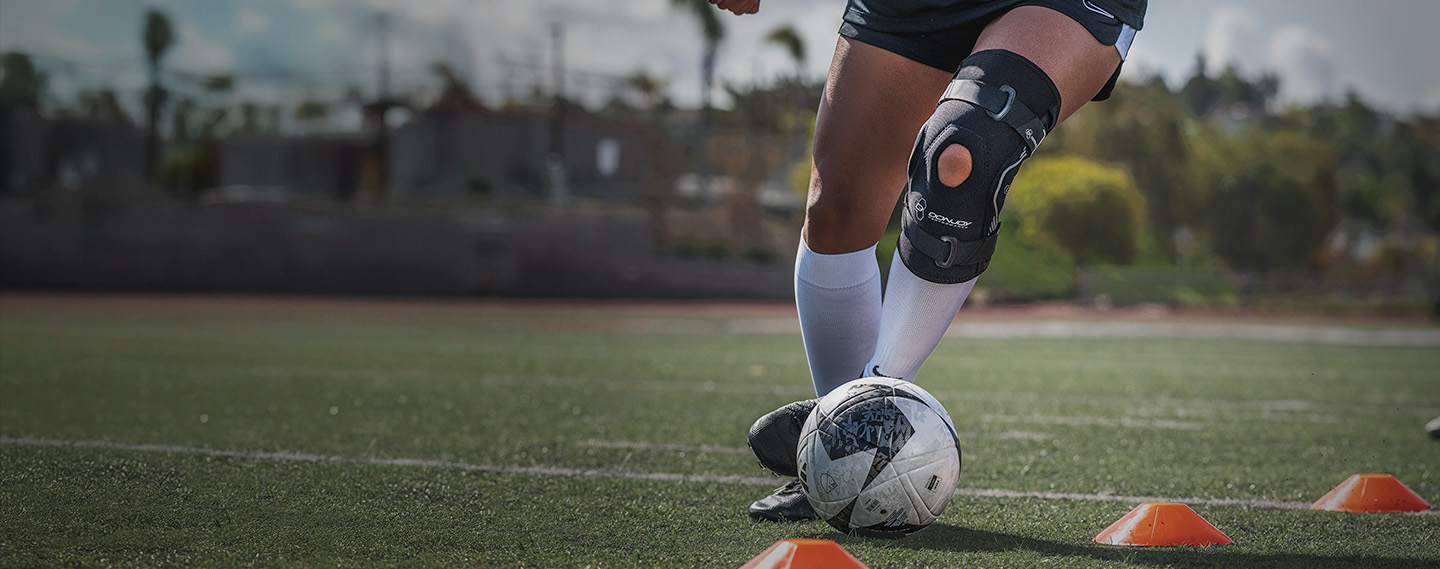 Athlete wearing Bionic Drytex Hinged Knee Sleeve while doing soccer drills