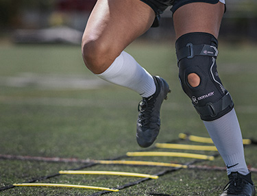 DonJoy Performance Bionic™ Drytex Hinged Knee Sleeve
 worn by and female athlete doing the ladder drill