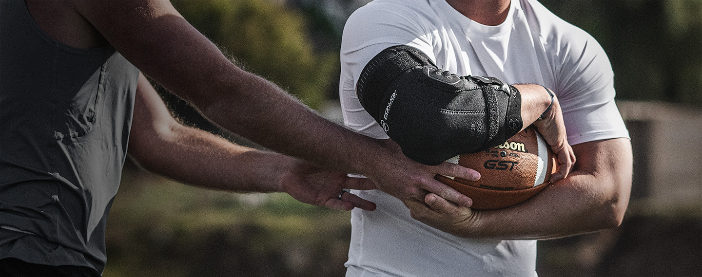 Athlete wearing a DonJoy Performance Bionic Elbow Brace playing football