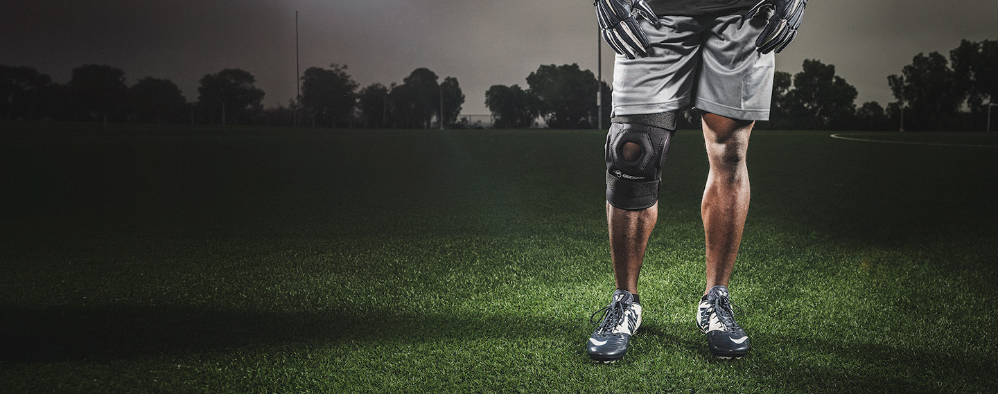 Athlete wearing bionic knee brace stand on a field