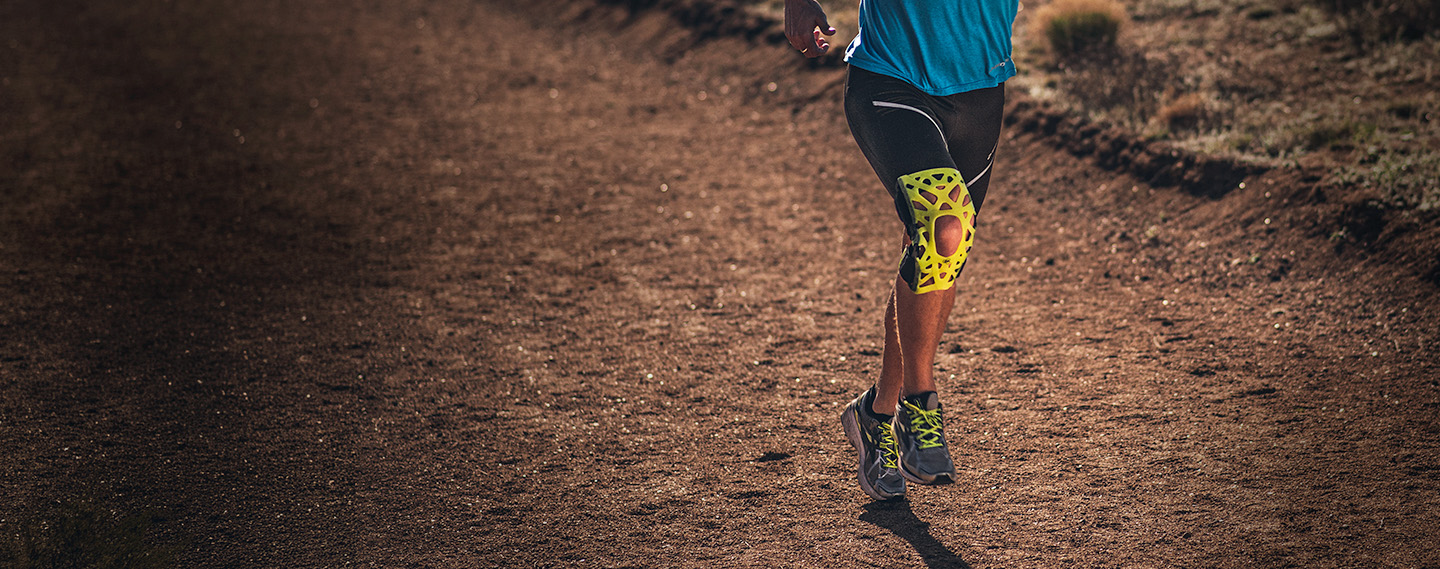 Athlete wearing webtech knee brace trail running